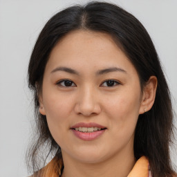 Joyful asian young-adult female with long  brown hair and brown eyes