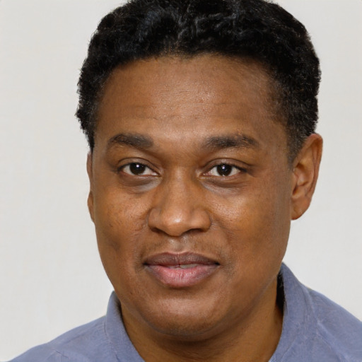 Joyful black adult male with short  black hair and brown eyes