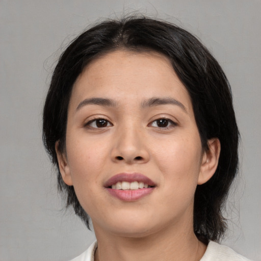 Joyful asian young-adult female with medium  black hair and brown eyes