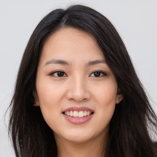 Joyful asian young-adult female with long  brown hair and brown eyes