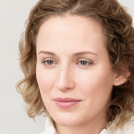 Joyful white young-adult female with medium  brown hair and blue eyes