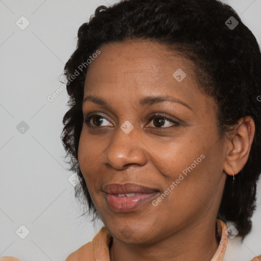 Joyful black adult female with medium  brown hair and brown eyes