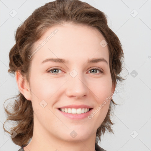 Joyful white young-adult female with medium  brown hair and blue eyes