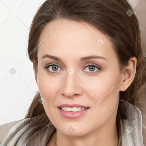 Joyful white young-adult female with long  brown hair and grey eyes