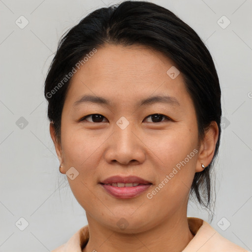 Joyful asian adult female with medium  brown hair and brown eyes