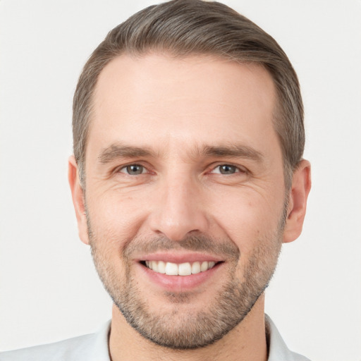 Joyful white young-adult male with short  brown hair and brown eyes