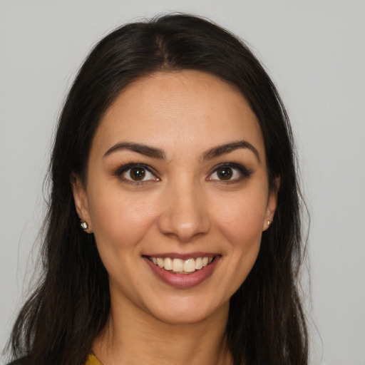 Joyful white young-adult female with long  brown hair and brown eyes