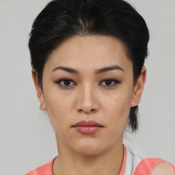 Joyful asian young-adult female with short  black hair and brown eyes