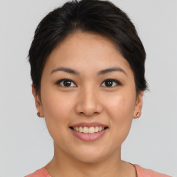 Joyful asian young-adult female with short  brown hair and brown eyes