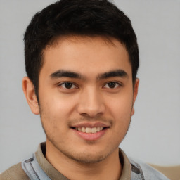 Joyful latino young-adult male with short  brown hair and brown eyes