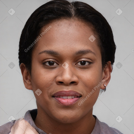 Joyful black young-adult female with short  brown hair and brown eyes