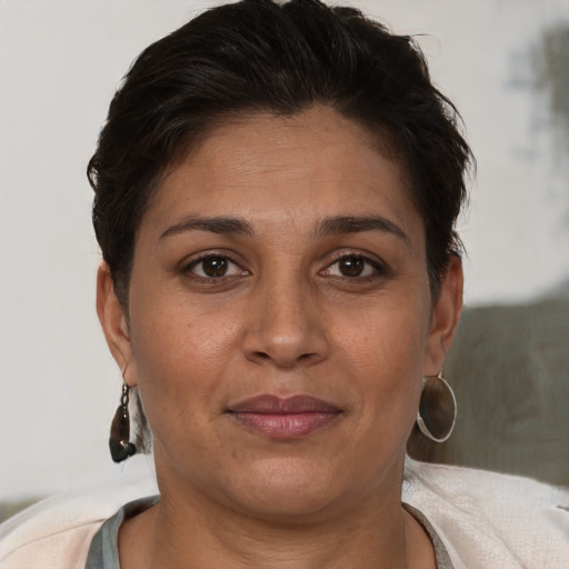 Joyful white adult female with short  brown hair and brown eyes