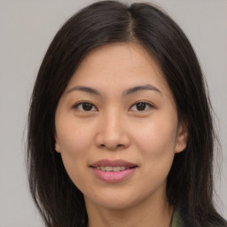 Joyful asian young-adult female with long  brown hair and brown eyes