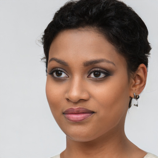 Joyful latino young-adult female with short  brown hair and brown eyes