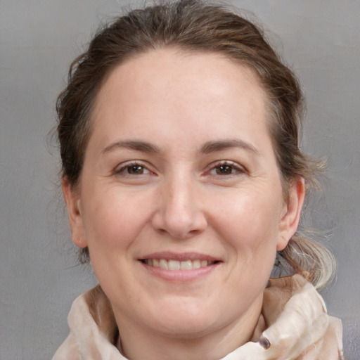 Joyful white adult female with medium  brown hair and brown eyes