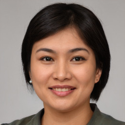 Joyful asian young-adult female with medium  brown hair and brown eyes