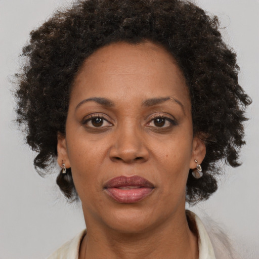 Joyful black adult female with short  brown hair and brown eyes