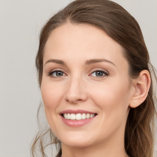 Joyful white young-adult female with long  brown hair and grey eyes