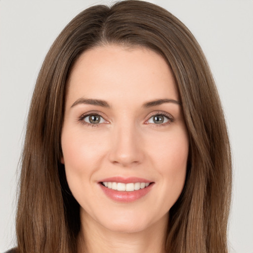 Joyful white young-adult female with long  brown hair and brown eyes