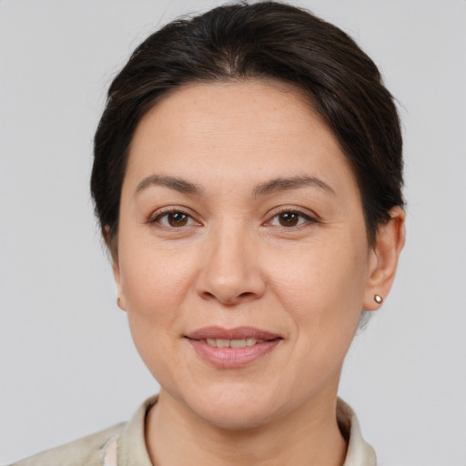 Joyful white adult female with short  brown hair and brown eyes