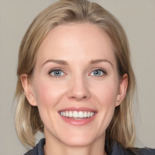 Joyful white young-adult female with medium  brown hair and blue eyes