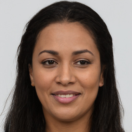 Joyful latino young-adult female with long  brown hair and brown eyes