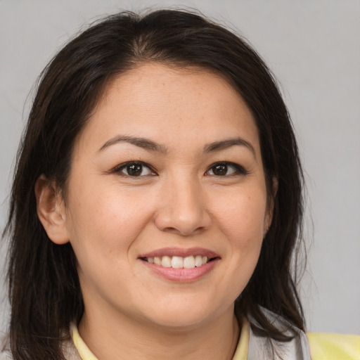 Joyful white young-adult female with medium  brown hair and brown eyes