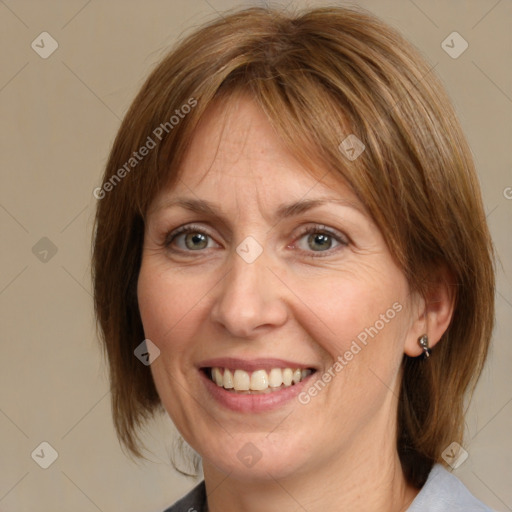 Joyful white adult female with medium  brown hair and grey eyes