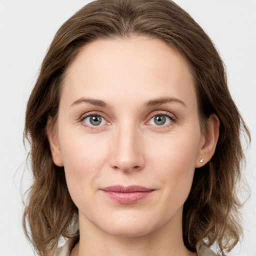 Joyful white young-adult female with medium  brown hair and green eyes