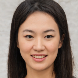 Joyful asian young-adult female with long  brown hair and brown eyes