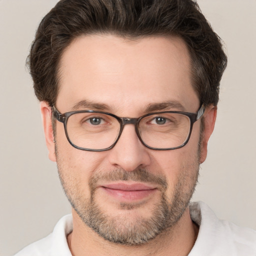 Joyful white adult male with short  brown hair and brown eyes