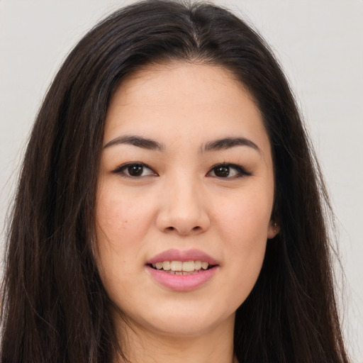 Joyful asian young-adult female with long  brown hair and brown eyes
