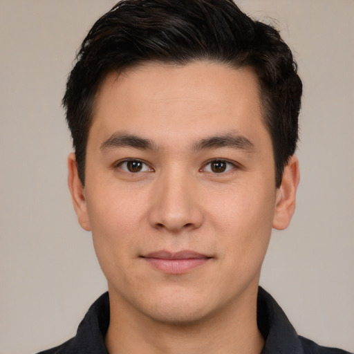 Joyful white young-adult male with short  black hair and brown eyes