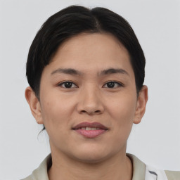 Joyful asian young-adult female with short  brown hair and brown eyes