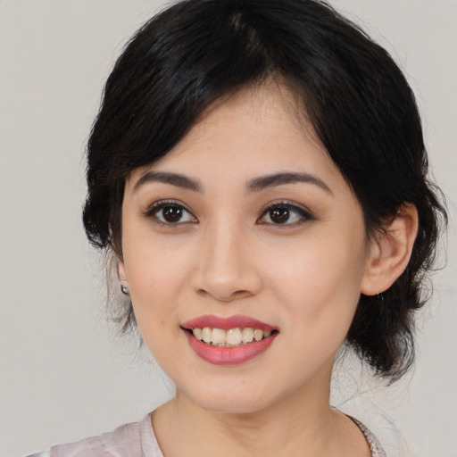 Joyful asian young-adult female with medium  black hair and brown eyes