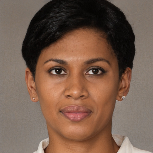 Joyful black young-adult female with short  brown hair and brown eyes