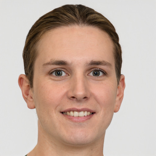 Joyful white young-adult male with short  brown hair and grey eyes