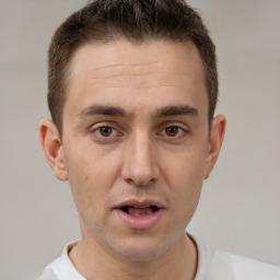 Joyful white young-adult male with short  brown hair and brown eyes