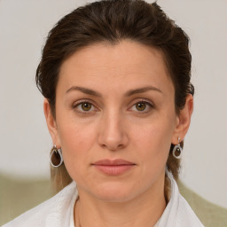 Joyful white young-adult female with medium  brown hair and green eyes