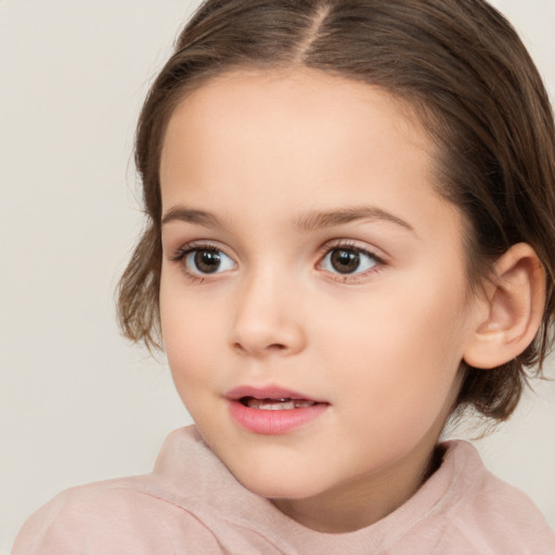 Joyful white child female with long  brown hair and brown eyes