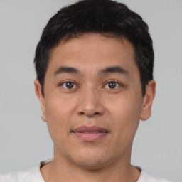 Joyful asian young-adult male with short  black hair and brown eyes