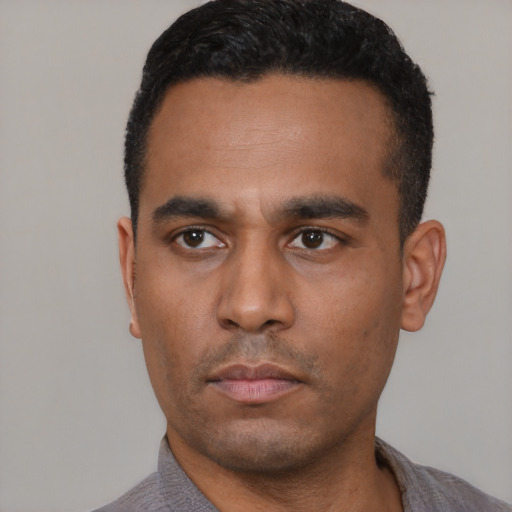 Neutral latino young-adult male with short  black hair and brown eyes