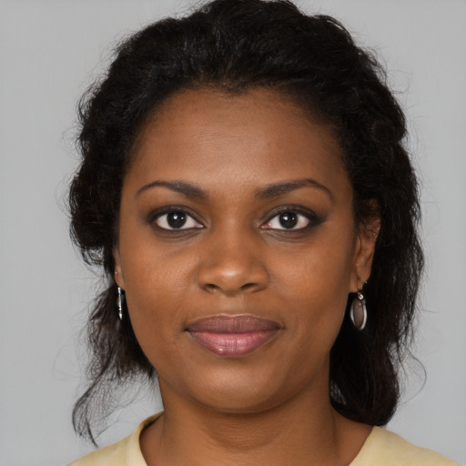 Joyful black young-adult female with medium  brown hair and brown eyes