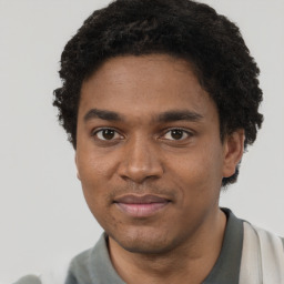 Joyful black young-adult male with short  brown hair and brown eyes