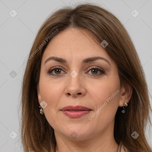 Joyful white adult female with long  brown hair and brown eyes