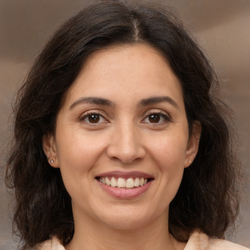 Joyful white adult female with medium  brown hair and brown eyes