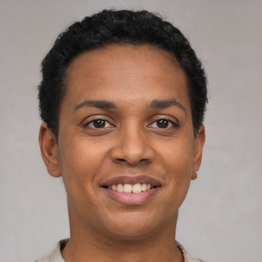 Joyful latino young-adult female with short  black hair and brown eyes