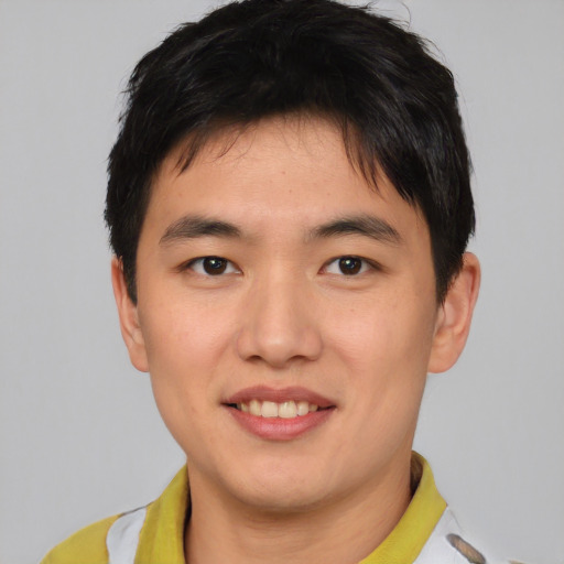 Joyful asian young-adult male with short  brown hair and brown eyes