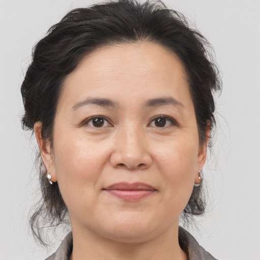 Joyful white adult female with medium  brown hair and brown eyes