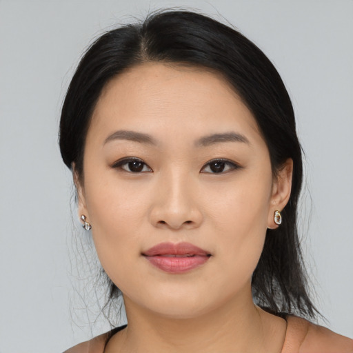 Joyful asian young-adult female with medium  black hair and brown eyes
